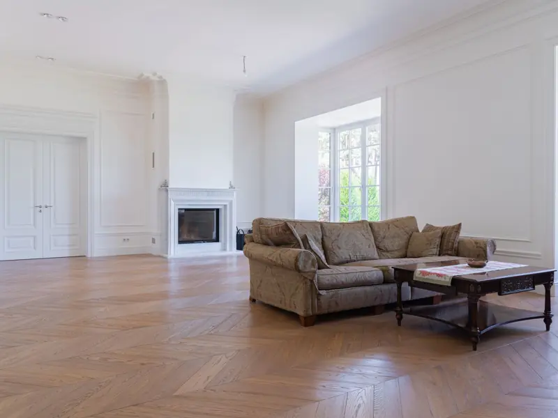 Beautiful spacious living room featuring elegant modern furniture and hardwood floors.