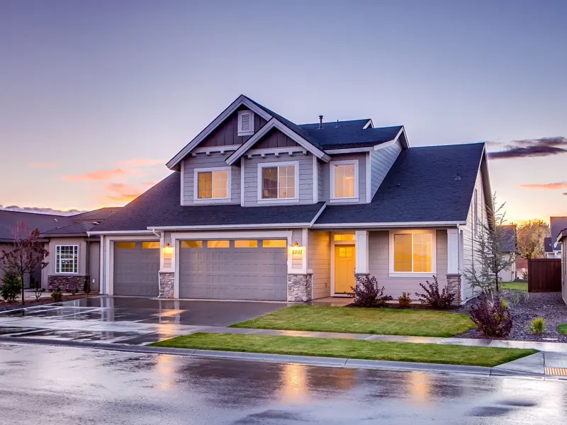 Elegant suburban home with driveway at sunset showcasing modern architecture.
