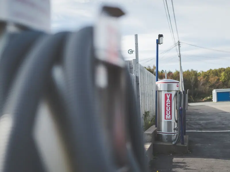Vacuum station at an outdoor car wash on a clear day with no people around.
