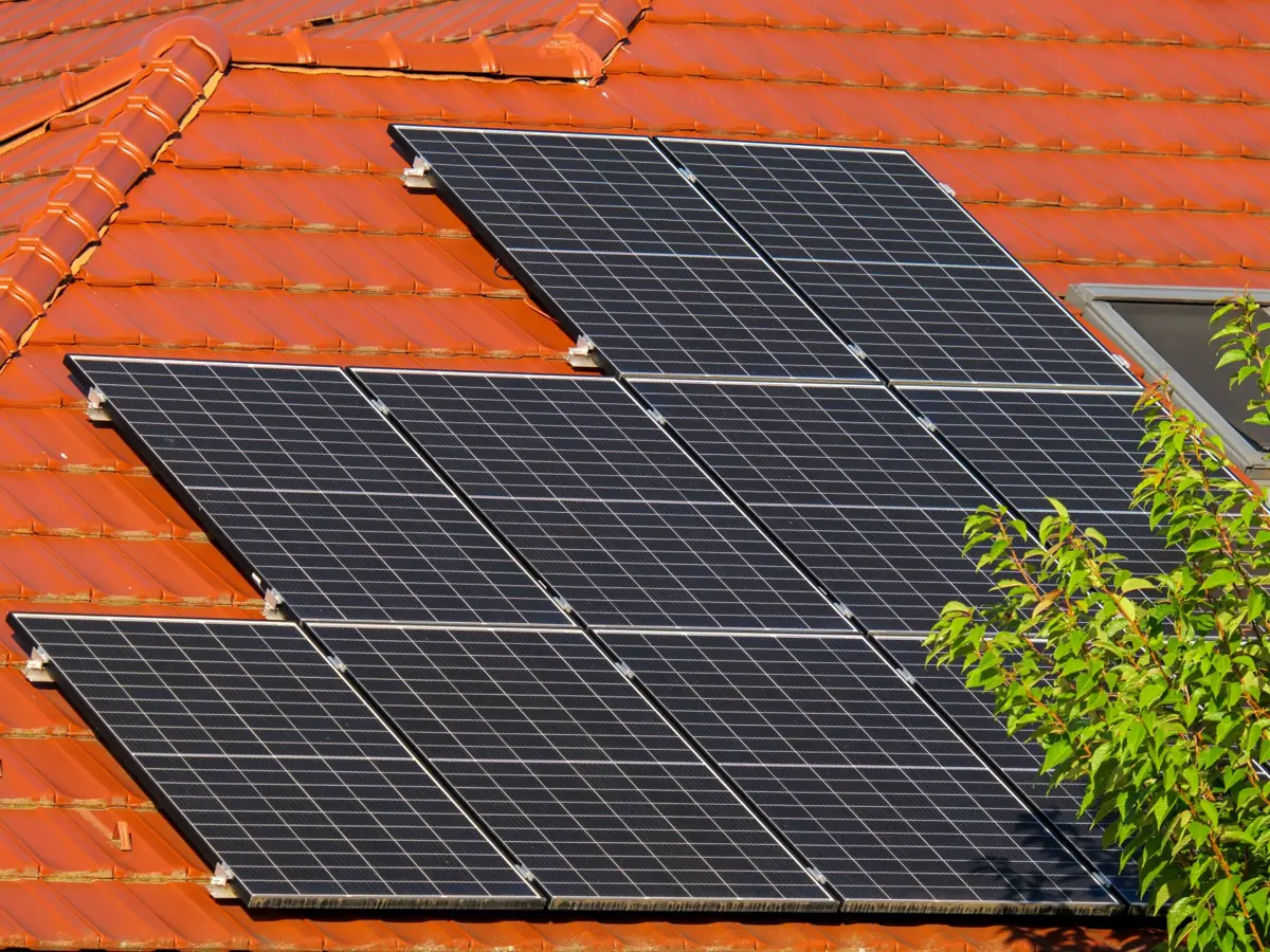 Close-up of solar panels on a red tiled roof in Croatia, highlighting renewable energy.