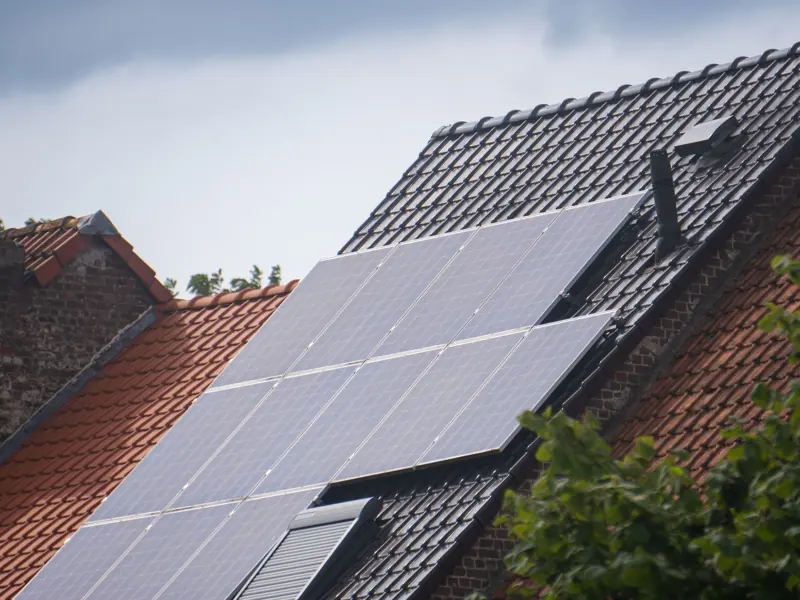 Solar panels installed on a residential rooftop, showcasing eco-friendly renewable energy solutions.