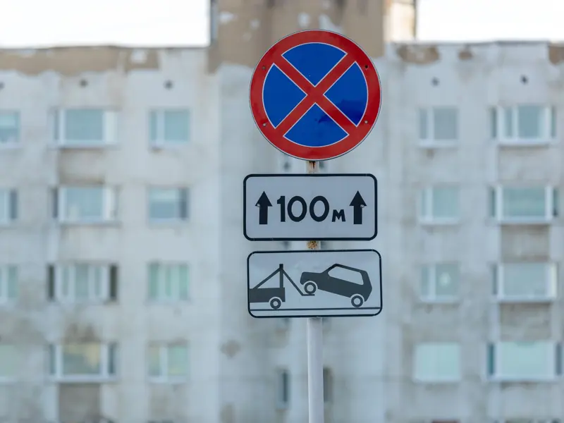 No parking sign in front of an old building facade, urban setting.